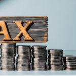Calculator, tax documents, and Indian currency notes representing comparison between old and new income tax regimes for ₹20 lakh salary